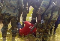 Abdul Rahaman Alhassan being guarded by Soldiers