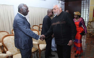 Rawlings greets Kufuor at a function.