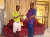 Headmaster presenting the plaque to Eugene Pencil