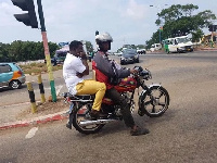 Kumi Guitar on a motorbike