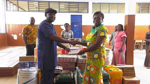 CEO of CBOD, Senyo Hosi presenting a cheque to the Headmistress of the school Mrs. Veronica Sackey