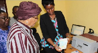 President Sirleaf receiving a copy of the new passport