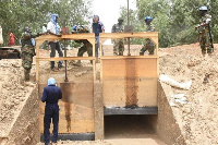 Some military men and workers at the site