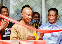 Ghana Consul General Hakim Bolugun cutting a sod for the opening of a Resource Hub