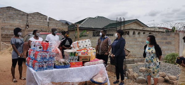 Stanbic team donating relief items to Covid-19 survivor, Frederick Drah