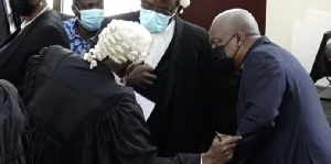 Former President John Mahama interacting with his counsel in court