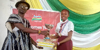 Joyce Asamoah Boateng receiving a prize on behalf of Supreme Saviour International School