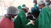 Surgeons at Soroti Regional Referral Hospital conduct an operation on conjoined twins