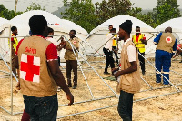 Red Cross officers mounting tents for the displaced persons