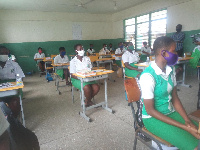 Some students wearing nose mask in class