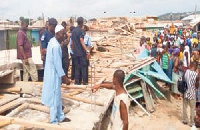 Security personnel at the site of the broken down building