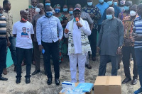 John-Peter Amewu, Minister of Energy presenting the items to a health facility