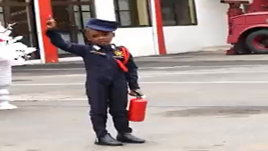 Janel Asantewaa Asante demonstrating to audience the accurate use of fire extinguisher