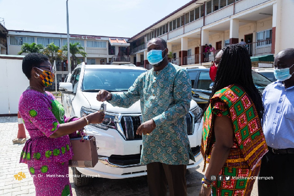 Dr Matthew Opoku Prempeh handing over the keys of one of the vehicles to a Director