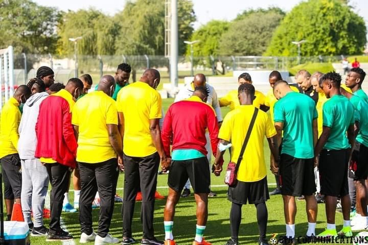 Black Stars and backroom staff hold a prayer session during a training session