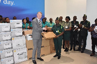 Liaison Officer of German Federal Police, Dirk Kattlun presenting items to Commander ACI Edith Arhin