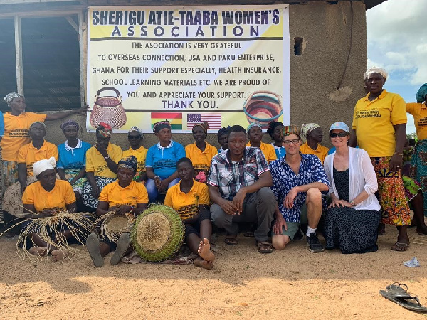 Steven Karowe and Paul Akurugu in group picture with some of the  beneficiaries