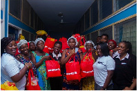 Executive Director of AFPNC (right) together with some mothers and officials of  Shoprite Ghana Ltd