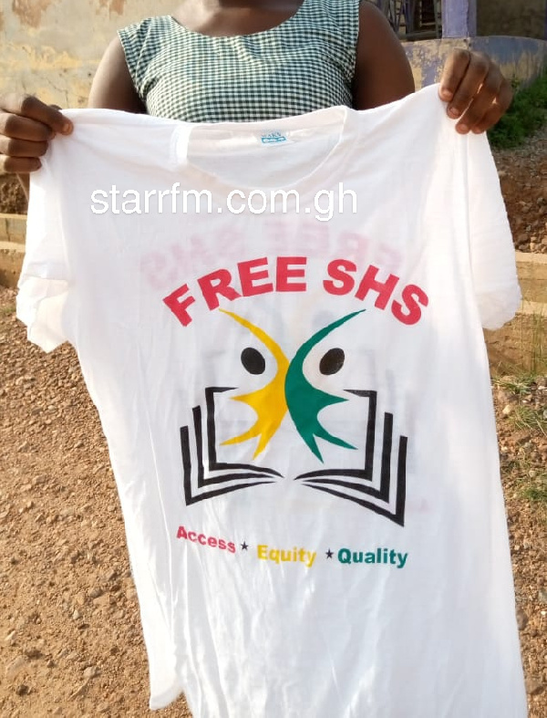 A photo of a student holding one of the printed T-shirts