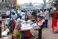 Traders in downtown, Kikuubo, Kampala go about their business