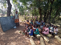 Some pupils of Naapaal studying under a tree