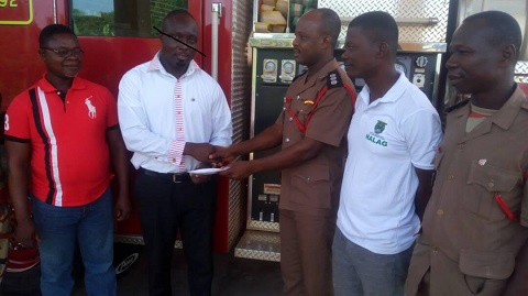 MCE nominee for Nzema East, Frank Okpenyen presenting the amount on behalf of the Minister