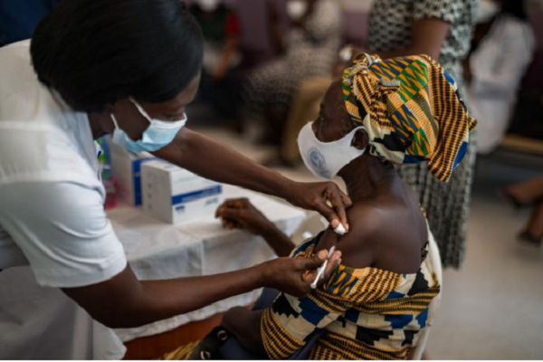 A resident being administered a covid-19 vaccination jab