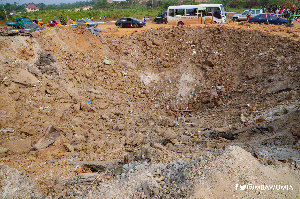 A crater created at the Apiate explosion site shows the impact of the accident