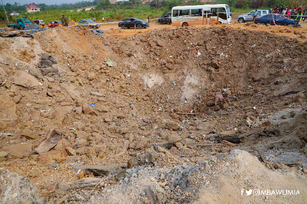 A crater created at the Apiate explosion site shows the impact of the accident