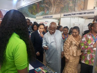 KT Hammond inspecting products at the Made-In-Ghana Bazaar