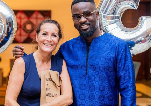 Sarkodie in a pose with the former French Ambassador, Anne Sophie Ave