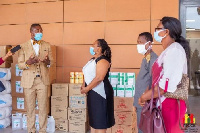 Ms Nkrumah receiving the PPE from Dr Bernard Okoe-Boye