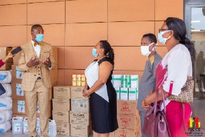 Ms Nkrumah receiving the PPE from Dr Bernard Okoe-Boye