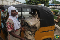 Abiba, one of the suspects with the siezed cartons of unwholesome chicken