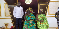 The Minister standing beside the Okyehene and Queenmother