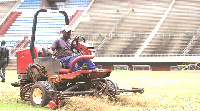 The matted turf on the field being worked on to help with drainage at the National Sports Stadium