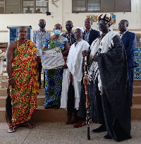 Headmaster of the Bueman SHS in a group picture with his citation