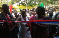 The MP with Mrs. Veronica Adzato-Ntem cutting the tape to open a new facility