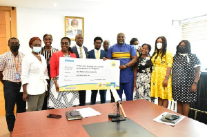 some executives and staff of MTN presenting the cheque to the Minister and her team