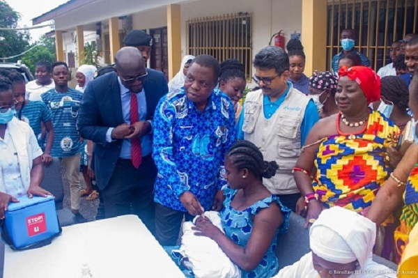 Mr Adu Gyan administering a drop to a child after the launch