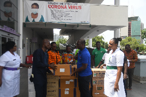 Solomon Phebe Owusu presenting the items to Dr Emmanuel Srofenyoh