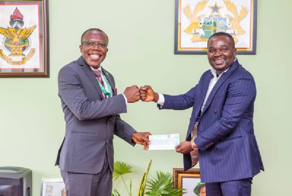 Professor Ellis Owusu-Dabo (left) receiving the cheque from Mr Ernest Akwasi Appiah