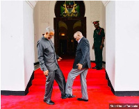 President John Magufuli (R) exchanging a foot greeting with opposition politician Maalim Seif Sharif