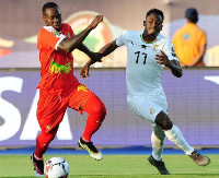 Baba Rahman takes on Juary Soares of Guinea-Bissau during the final group stage game