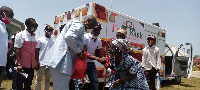 Emmanuel Armah Kofi Buah giving food items to some constituents