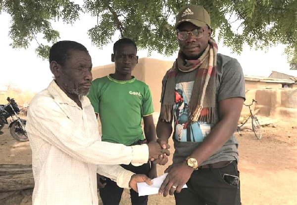 Blind farmer receiving donation