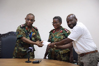 Mr. Hosi handing the cheque over to Brigadier General Nii Adjah Obodai