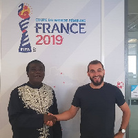 Sarfo (L) in a handshake with Benoit Boisson at the FIFA Headquarters in Paris earlier this month