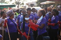 Some female staff of Jospong group cheerfully cleaning up the market