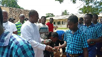 Hon. Alex Afenyo-Markin donating the mathematical sets to some of the students